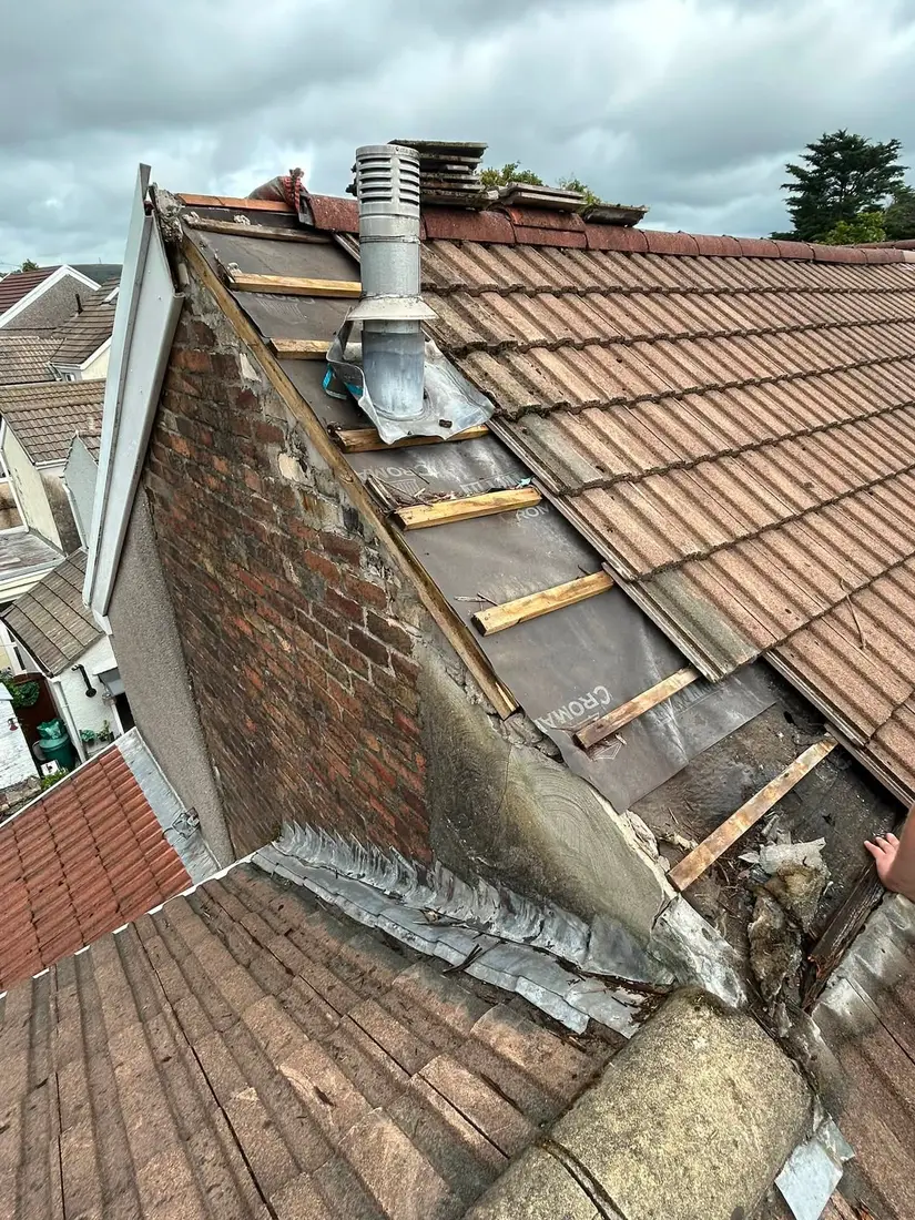 Before: Stripped verge, new flashing and re-laid tiles on a pitched roof
