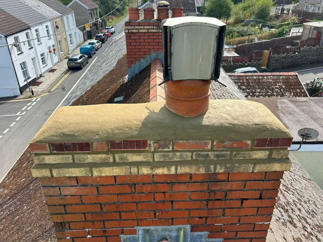 After: Moss and growth cleared from a chimney stack, with new flaunching